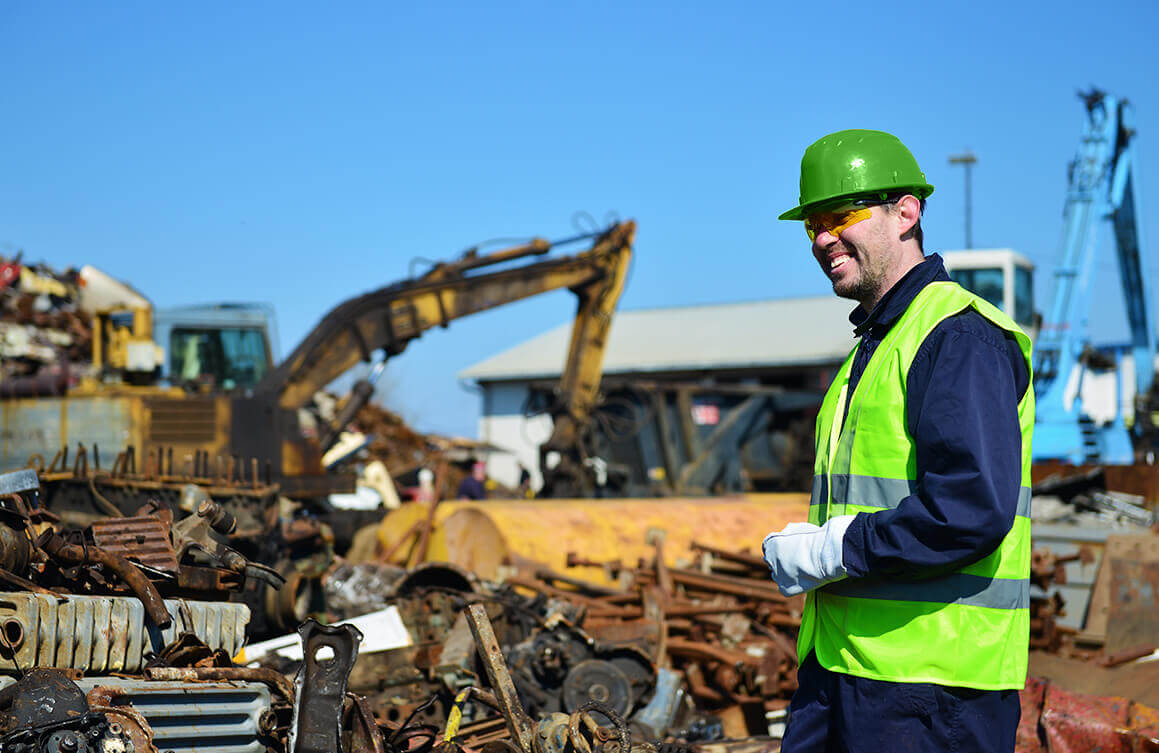 man smiling in the metal recycling site
